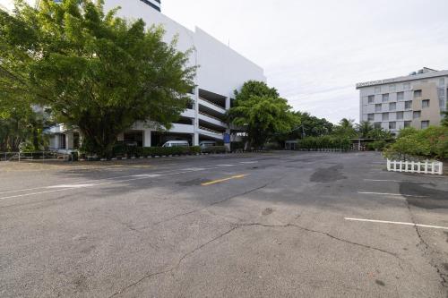 an empty parking lot in front of a building at Royal Phuket City Hotel in Phuket Town