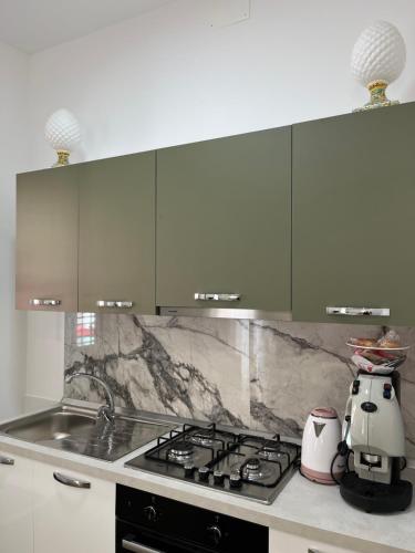 a kitchen with a stove and a counter top at Al canto del Muezzin - Apartment in Mazara del Vallo