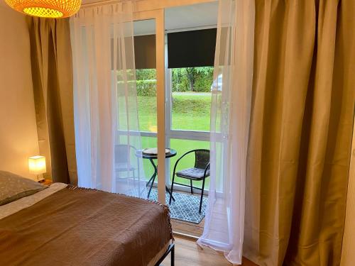 a bedroom with a bed and a large window at Donaustern in Passau