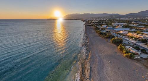 an aerial view of a beach at sunset at Votsalo in Ierápetra