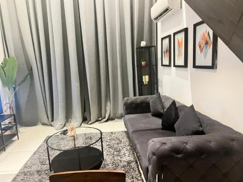 a living room with a couch and a table at Embassy Gardens Royal Suites Apartments in Accra