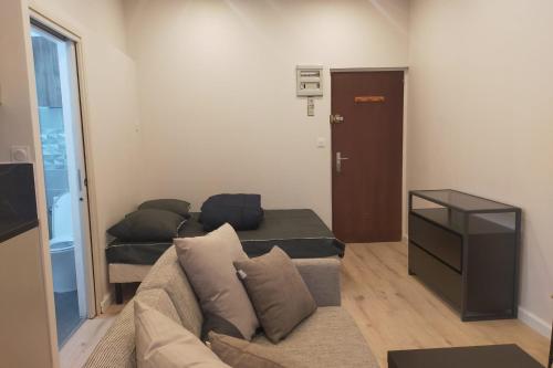 un salon avec un canapé et une porte dans l'établissement #FP The Golfer's Nest - Studio - Uriage, à Vaulnaveys-le-Haut