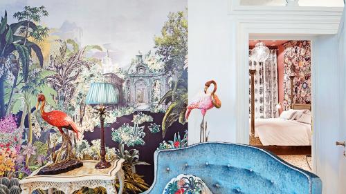 a bedroom with a mural of birds on the wall at Hotel Heureka in Venice
