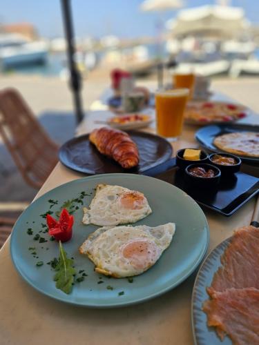 a table with plates of breakfast foods on them at Nyx Chic Manor in Chania Town