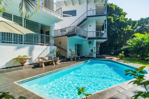 an image of a swimming pool in front of a building at Beside Still Waters Boutique Hotel in Durban