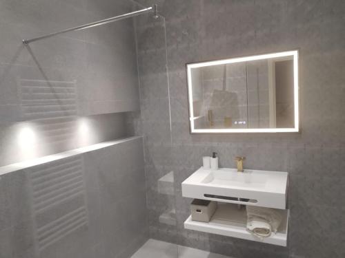 a bathroom with a white sink and a mirror at Villa haut standing avec piscine chauffée sans vis-à-vis et hammam in Ouled Moussa