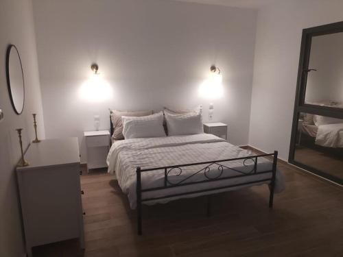 a bedroom with a bed and a mirror and lights at Villa haut standing avec piscine chauffée sans vis-à-vis et hammam in Ouled Moussa