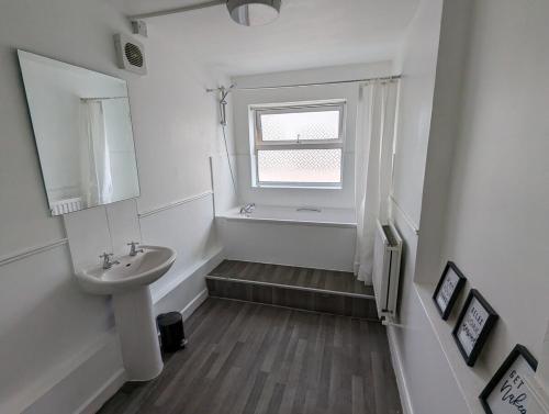 a white bathroom with a sink and a window at Ethos Hotel in Oxford