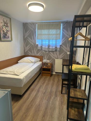 a bedroom with a bunk bed and a ladder at Hotel Pirol in Berlin