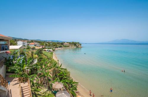 a view of a beach with people swimming in the water at Kozanos Studios 1 in Amoudi