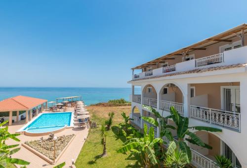 an aerial view of a resort with a swimming pool and the ocean at Kozanos Studios 1 in Amoudi