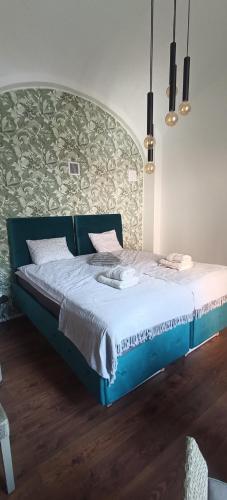 a bed in a room with a blue bed frame at Apartman na Pekarske in Brno