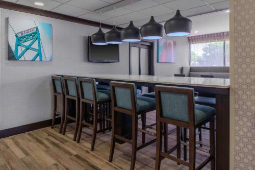 a bar in a room with chairs and a counter at Hampton Inn Detroit Northville in Northville