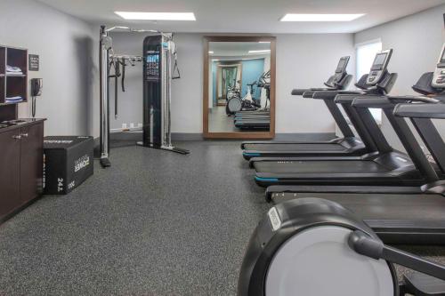 a gym with several treadmills and a mirror at Hampton Inn Detroit Northville in Northville