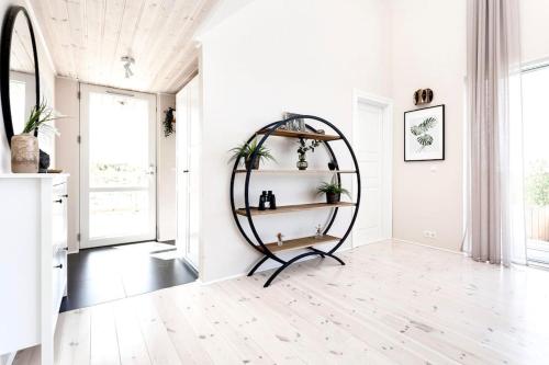 a hallway with a round shelf in a white room at Northern lights Luxury with hot tub! 10 min to city in Mosfellsbær