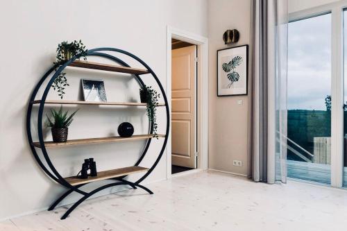 a room with a shelf with plants and a window at Northern lights Luxury with hot tub! 10 min to city in Mosfellsbær