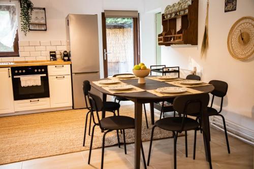 a kitchen with a table and chairs in a room at ADORA River Retreat in Avrig