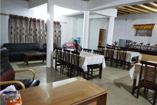 a dining room with a table and chairs and a table and chairsktop at Kailash Nubra Valley Ladakh by LexStays in Nubra