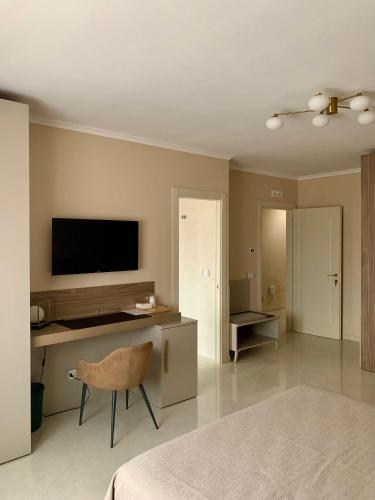 a bedroom with a desk with a television and a chair at Anna House in San Marco dei Cavoti