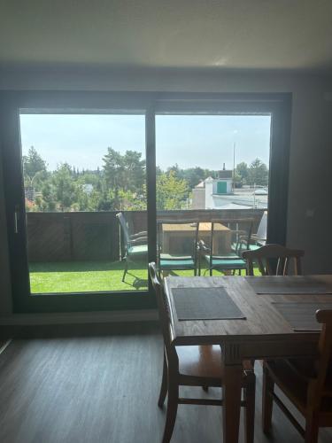 a room with a table and chairs and a large window at Hotel Pirol in Berlin