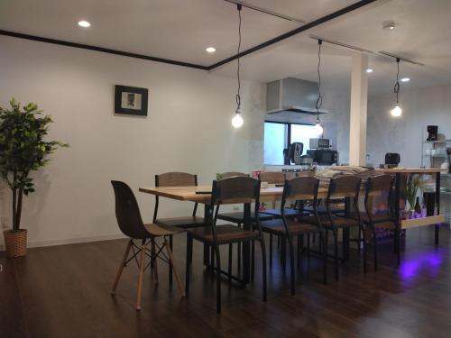 a dining room with a table and chairs at NorthHisath-Susukino in Sapporo