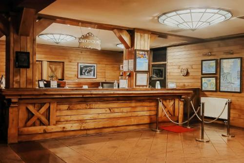 a bar in a room with wooden walls at Wyndham Garden Ushuaia Hotel del Glaciar in Ushuaia