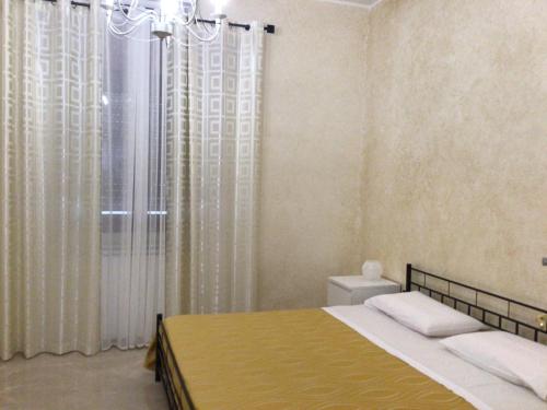 a bedroom with a bed and a chandelier at Tramonti salentini in San Marzano di San Giuseppe