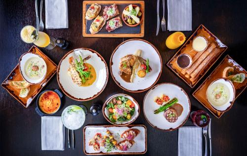 a table with plates of food on it at Hyatt Regency Oryx Doha in Doha