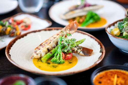a plate of food with vegetables on a table at Hyatt Regency Oryx Doha in Doha