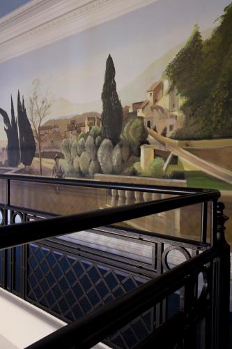 a painting of fruits and vegetables on a wall at Logis Le Midland in Vichy