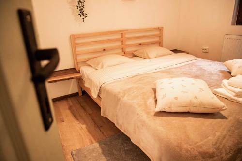 a bedroom with a large bed with two pillows at ADORA River Retreat in Avrig