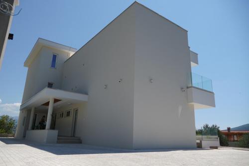 a white building with a pyramid shape at Villa Le Grand Bleu in Ðenovići