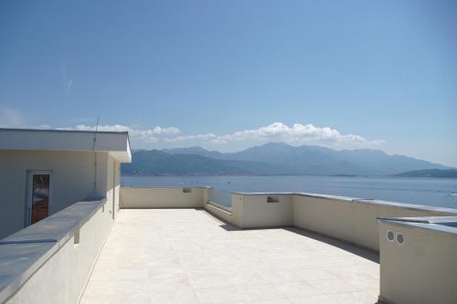 a balcony with a view of the water and mountains at Villa Le Grand Bleu in Ðenovići