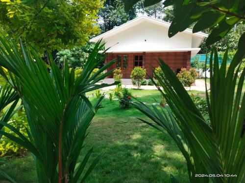 a house in the middle of a yard at Merlys Fruit Garden in Cochin