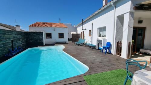 a swimming pool on a wooden deck next to a house at House of Arts in Corroios