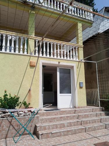 a house with stairs and a white door at гостевой дом Polina2 in Gornji Sušanj