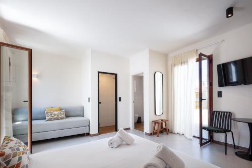 a living room with a bed and a couch at Aristea Hotel in Rethymno Town