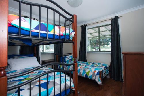 a bedroom with two bunk beds and a window at Nutcrackers Lodge in Esperance
