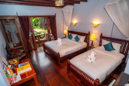 Cama o camas de una habitación en Muangthong Boutique Hotel