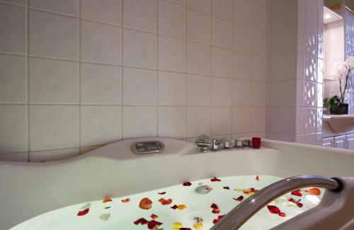 a bathroom with a tub with flowers on it at Logis Le Midland in Vichy