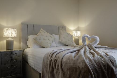 a bed with a blanket with a heart on it at The Place by Sasco in Blackpool