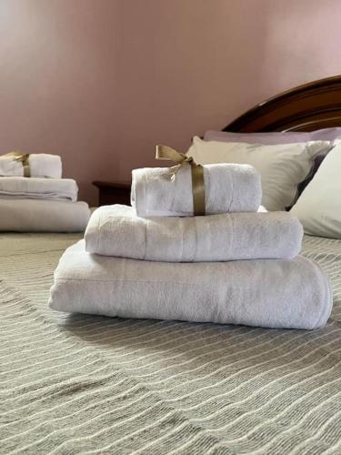 a stack of towels on a bed in a room at Il Baco da Seta in Sale San Giovanni