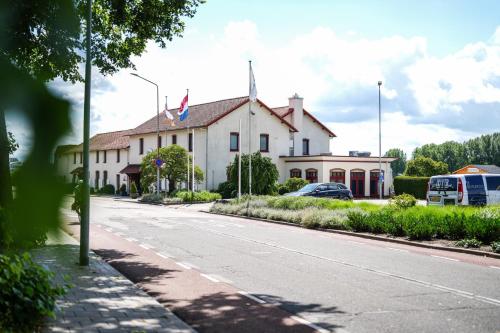 a white building with a bus parked in front of it at Valuas in Venlo
