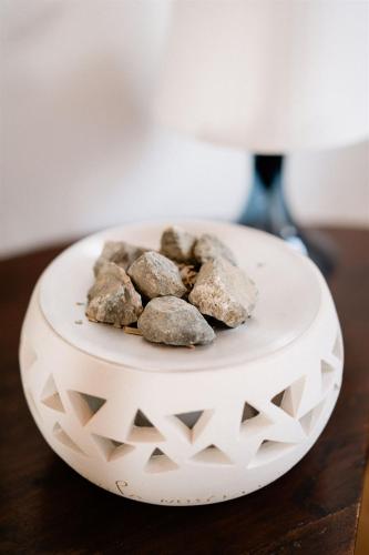 a white bowl with rocks on top of a table at in lak'ech - rooms in Chironico