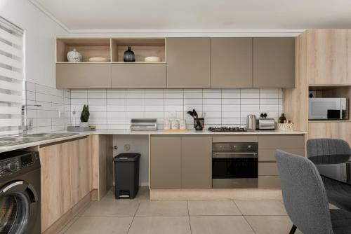 a kitchen with a stove and a dishwasher at Waters Edge Apartments in Cape Town