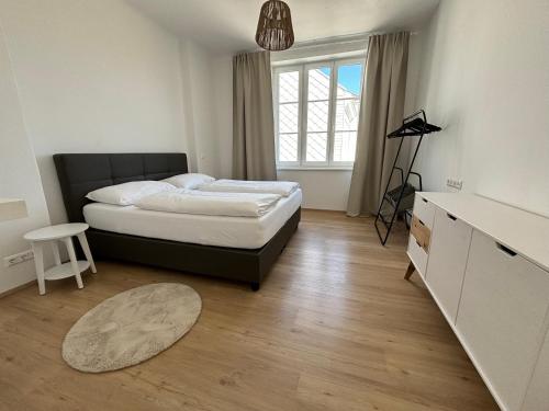 a bedroom with a bed and a table and a window at Apartment Hafingervilla in Sankt Pölten