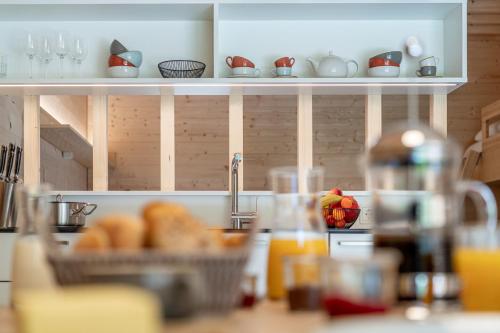 a kitchen with a counter with a basket of bread at Apartment am Camping Dornbirn - 212 Salzbödenkopf in Dornbirn