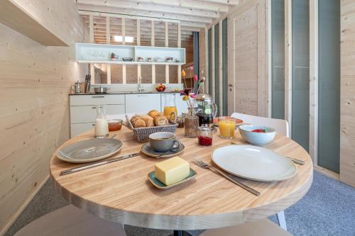 a wooden table with food on it in a kitchen at Apartment am Camping Dornbirn - 211 Hangspitze in Dornbirn