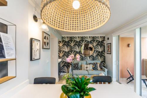 a dining room with a large chandelier at The Palms Coconut Grove 1 bedroom condo includes parking in Miami