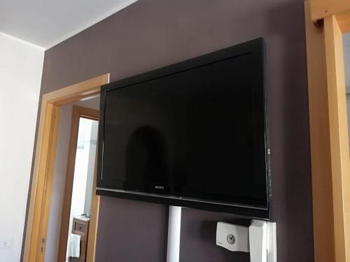 a flat screen tv hanging on a wall at La Casa di Giulia in Otranto